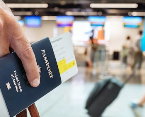 Traveler holding passport at airport – Super Visa insurance Canada