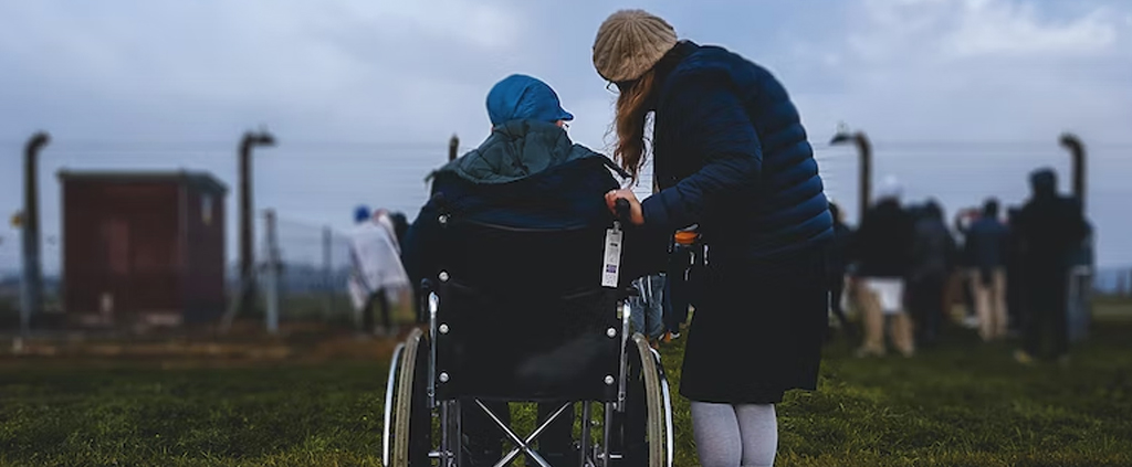 Woman in a wheelchair with caregiver – disability insurance coverage Canada